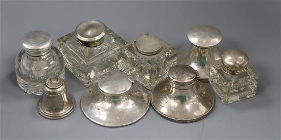 Eight assorted Edwardian and later silver mounted inkwells.